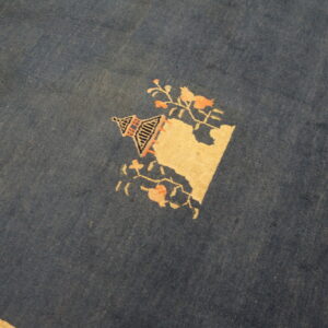 Blue rug with floral design elements.