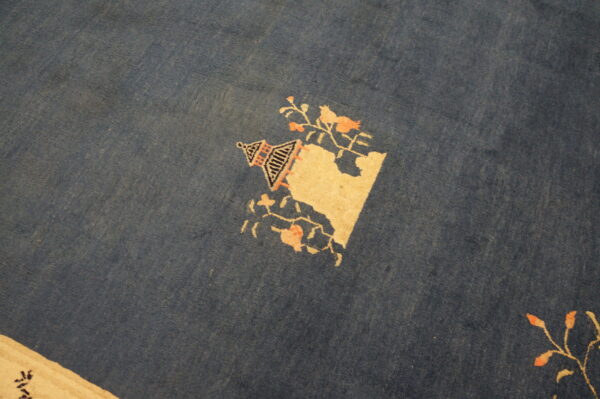Blue rug with floral design elements.