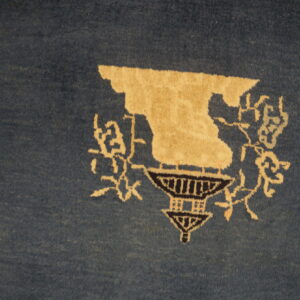 Blue rug with cream floral design.