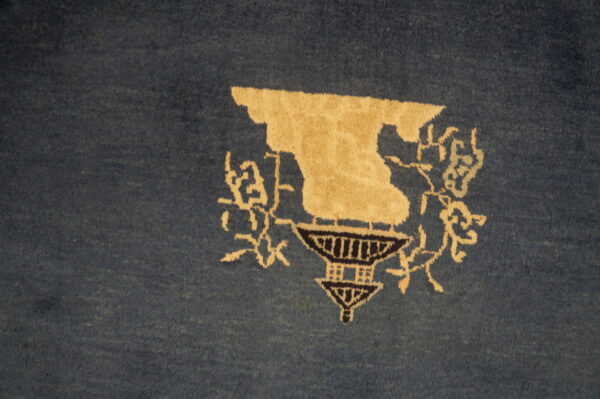 Blue rug with cream floral design.