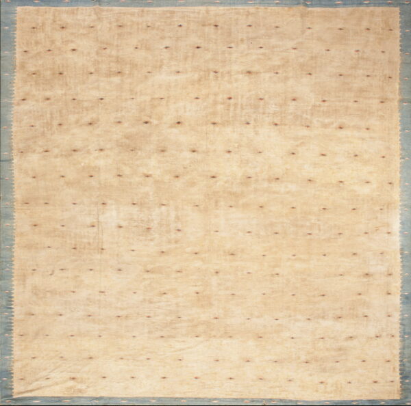 Beige rug field scattered with small red and navy diamonds, bordered by wide scalloped blue banding.