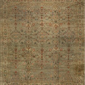 Traditional rug with a muted blue-gray field, detailed floral motifs, and wide khaki-toned borders.