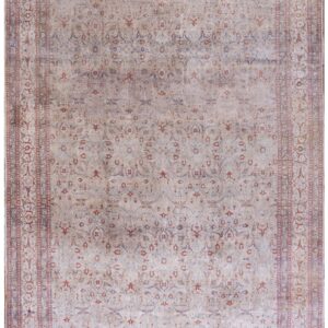 A traditional low-pile area rug featuring faded beige, rust, and blue intricate patterns.