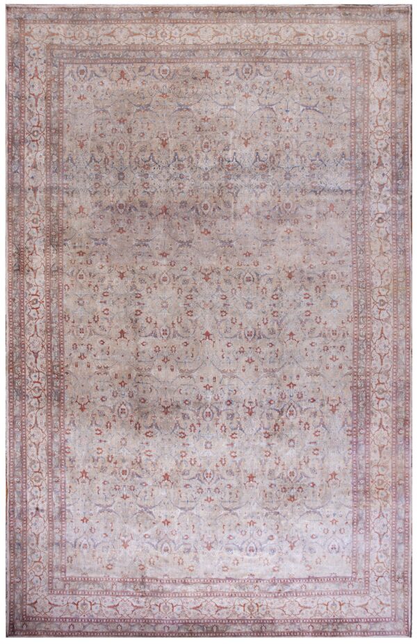 A traditional low-pile area rug featuring faded beige, rust, and blue intricate patterns.
