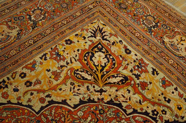 Ornate rug corner featuring large palmette motifs in rust, navy, and gold on a pale green ground.