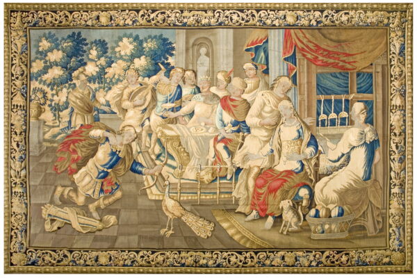 Large flat-woven tapestry depicting a classical banquet scene with figures, blue foliage, and an ornate gold and dark border.