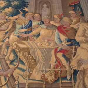 Woven historical scene of a king and attendants in rich blue, gold, and red fabric.