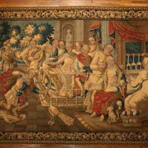 A large tapestry rug featuring a classical banquet scene in beige, blue, green, and red tones.