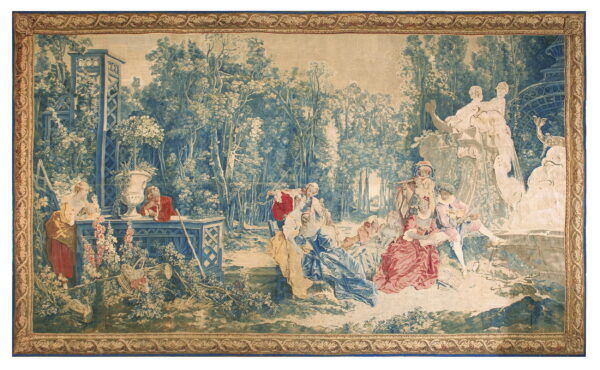 A large woven wall hanging with a detailed blue and tan pastoral scene and an ornate golden border.