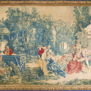 Detailed tapestry featuring a pastoral scene with figures in period dress and an ornamental border.