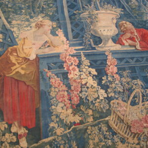 Historical tapestry with two figures in red and yellow leaning on a blue trellis, surrounded by pale pink flowers.