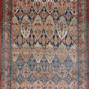 Ornate traditional rug with a trellis medallion pattern in navy blue, rust red, and faded beige.
