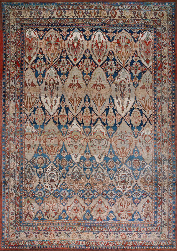 Ornate traditional rug with a trellis medallion pattern in navy blue, rust red, and faded beige.