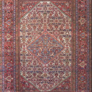 Red bordered oriental rug featuring an ivory field with an intricate floral and stepped geometric blue medallion.
