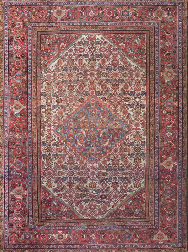Red bordered oriental rug featuring an ivory field with an intricate floral and stepped geometric blue medallion.