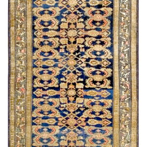 Narrow low-pile runner with a navy blue field, tan palmette motifs, and complex geometric borders.