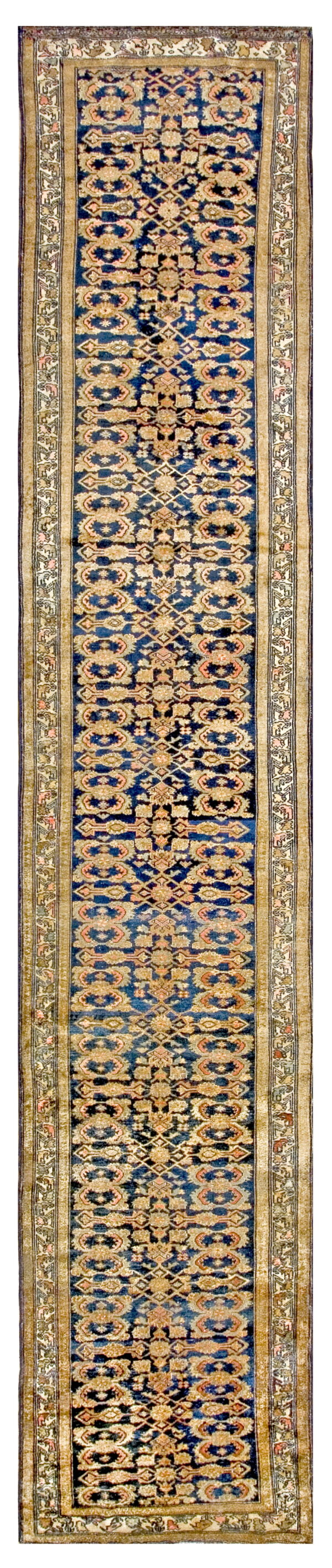 Narrow low-pile runner with a navy blue field, tan palmette motifs, and complex geometric borders.