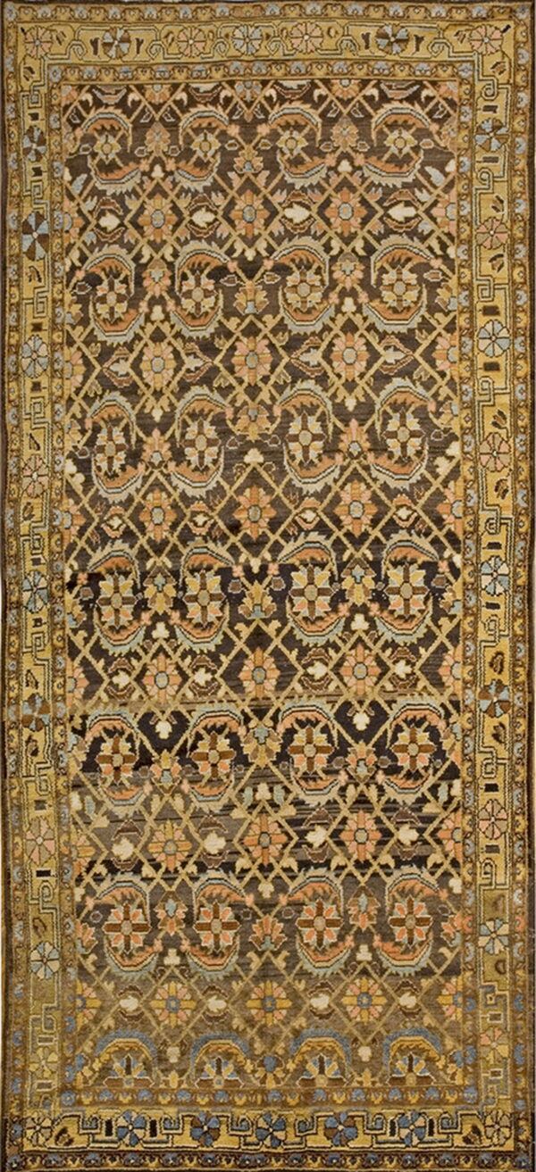Rectangular rug featuring a dark field, gold border, and repeating tan, peach, and blue floral motifs.