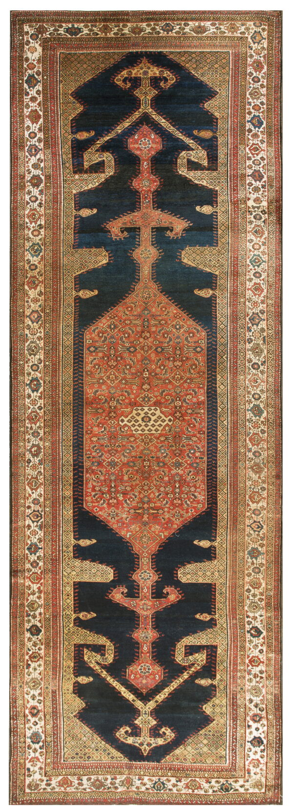 Traditional runner rug featuring a dark blue field surrounding a detailed red and tan stepped medallion.