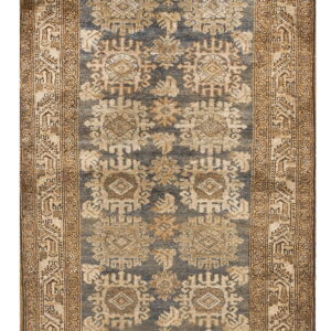 Distressed blue runner rug featuring tan geometric medallions and a complex, wide brown border.