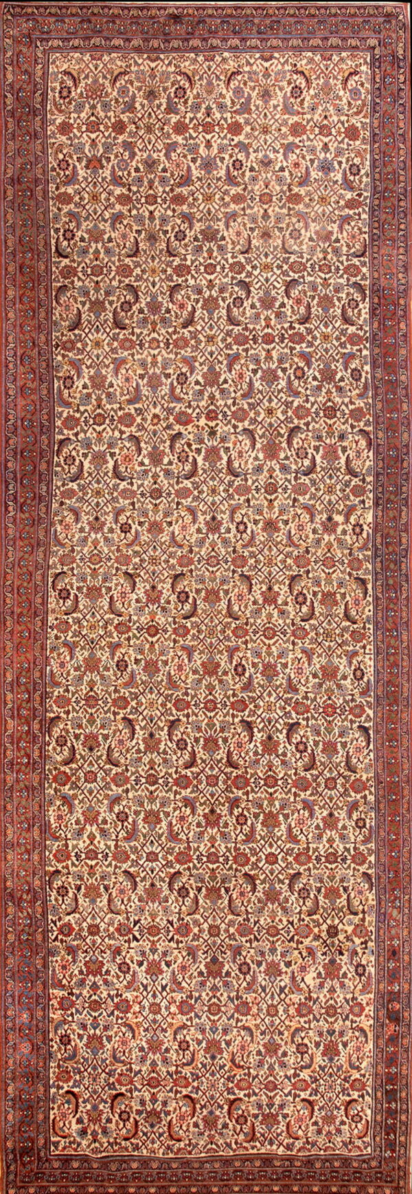 Long runner rug with a dense red, blue, and brown botanical pattern on an ivory field and a multi-layered border.