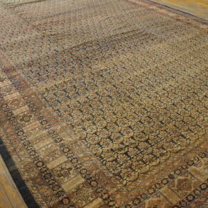 Large, distressed rug featuring dense gold and navy patterns, laid over light hardwood floors.