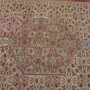 Intricate floral pattern on wool rug.