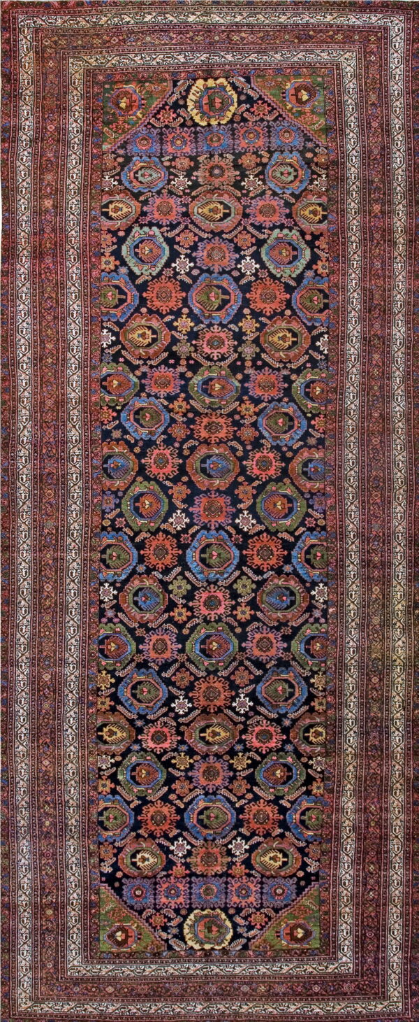 Dark runner rug with repeating colorful geometric medallions and wide borders in shades of red and ivory.