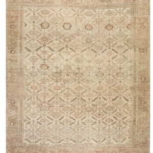 Low pile rug featuring a dense geometric design in faded tan, brown, and pale red on a cream field.