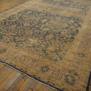 Low-pile rug featuring a distressed navy and rose floral pattern on light brown wood planks.