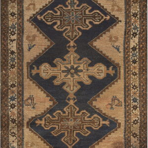 Geometric rug with dark blue diamonds and cross motifs on a beige field surrounded by patterned borders.