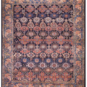 Dark blue rug with alternating bands of geometric and medallion motifs in coral, rust, and light blue.