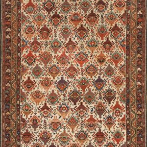 Low-pile rug with dense repeating rust, blue, and brown stylized patterns on a cream background.