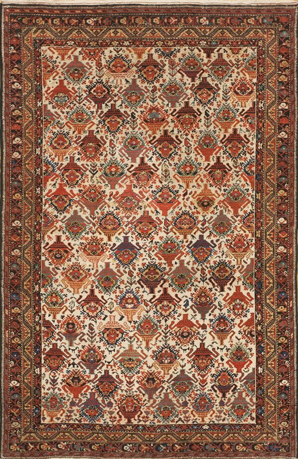 Low-pile rug with dense repeating rust, blue, and brown stylized patterns on a cream background.