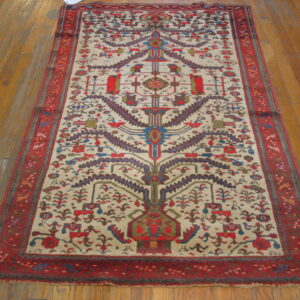 Rectangular rug with a cream field, central multicolor tribal motif, and red borders on wooden floors.