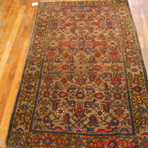 Traditional runner with dense red, blue, and gold patterns over a tan field on hardwood floors.