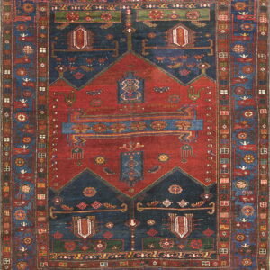 Full view of a geometric patterned rug with a red stepped center panel on a blue ground.