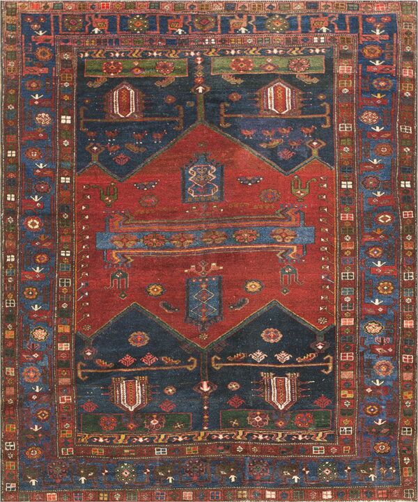 Full view of a geometric patterned rug with a red stepped center panel on a blue ground.