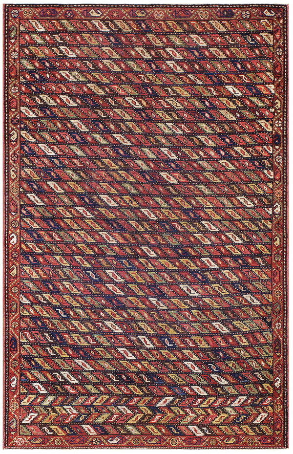 A rectangular rug with a red field patterned with repeating diagonal diamonds in navy, yellow, and white.