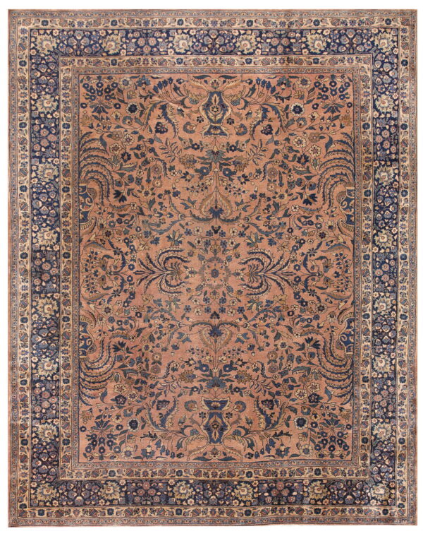 Low-pile rug featuring a terracotta pink field with navy blue intricate formal floral designs.