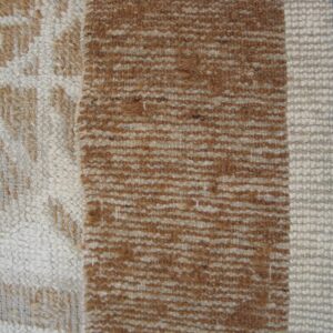 Close weave showing chunky white, brown, and blue vertical stripes next to a tan patterned section.