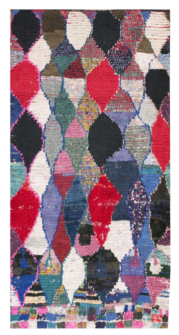 Shaggy multicolor rug with an irregular patchwork design of overlapping red, black, and bright diamonds.
