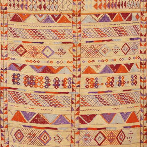 Cream rug with a vertical seam and banded geometric patterns in orange, red, and purple.