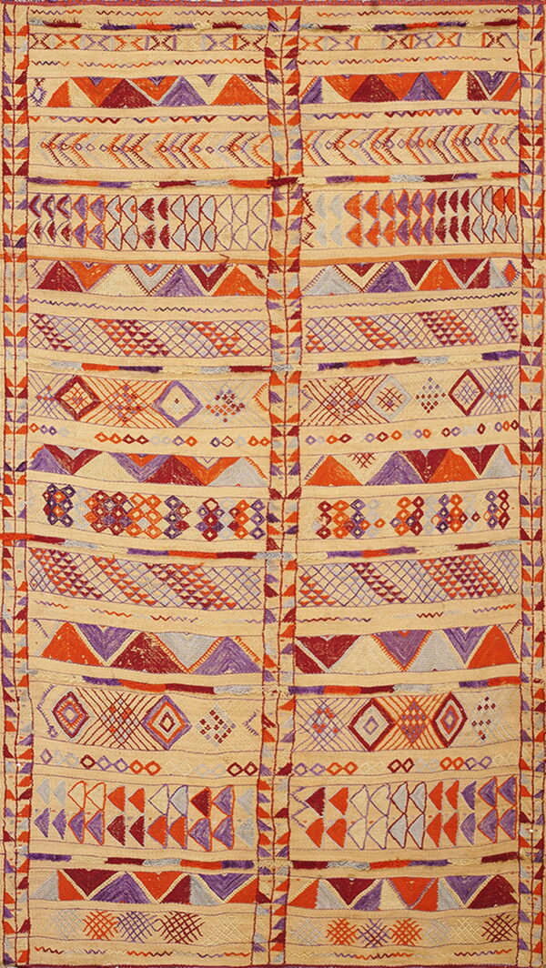 Cream rug with a vertical seam and banded geometric patterns in orange, red, and purple.