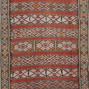 Rust red flatwoven rug with horizontal bands of white, green, and yellow geometric patterns.