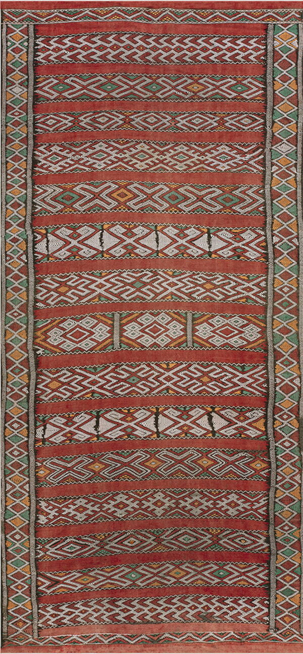 Rust red flatwoven rug with horizontal bands of white, green, and yellow geometric patterns.