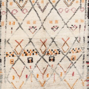 Cream high-pile rug featuring an irregular diamond lattice pattern and geometric motifs in black, orange, and pink.