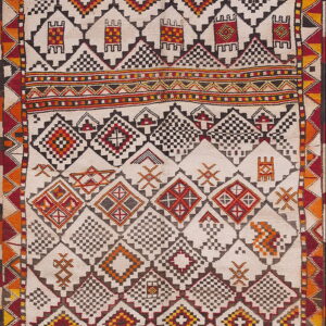 Geometric cream rug featuring complex diamond and stepped patterns bordered in red, black, and yellow.