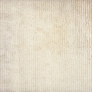 Textured off-white rug with a high shaggy pile arranged in distinct vertical ribs.