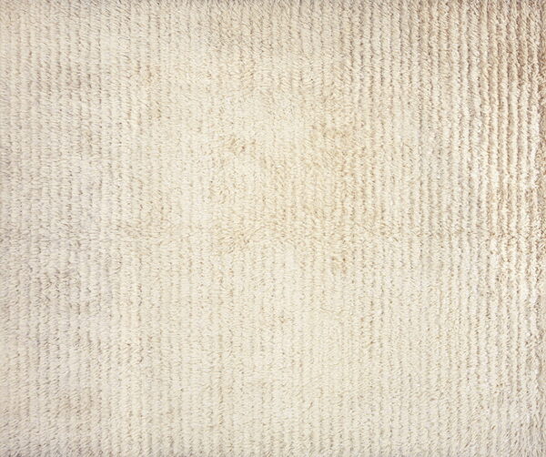 Textured off-white rug with a high shaggy pile arranged in distinct vertical ribs.